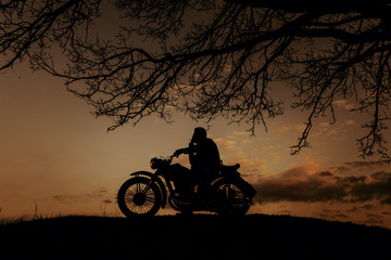 Obraz na płótnie Canvas Silhouette of a biker against the sunset.