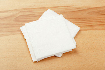 white paper napkin or tissue on the wooden table background.