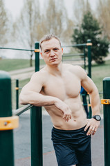 Fitness man with perfect body doing abdominal exercises in the Gym..