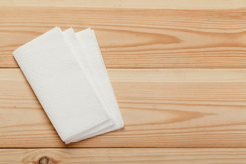 white paper napkin or tissue on the wooden table background.
