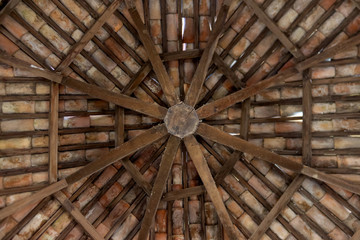 Attic of a bell tower. highlights the exposed wooden beams and the roofing of tiles
