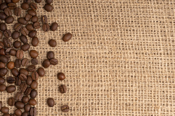 Frame of roasted coffee beans on sack fabric