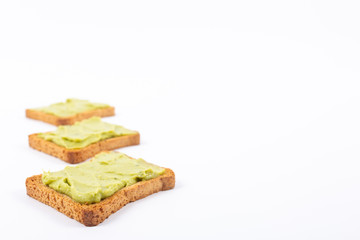 Toast with avocados on a white background. Healthy nutrition
