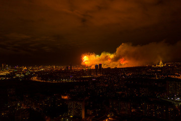 fireworks in the center of a big city at night filmed from a drone