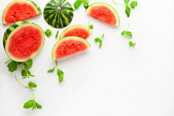 Slices of fresh watermelon on white background. Summer concept of healthy food. Flat lay, copy space.