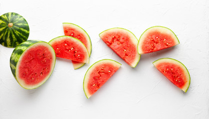 Slices of fresh watermelon on white background. Summer concept of healthy food. Flat lay, copy space.
