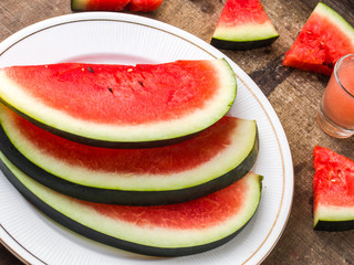 Sliced Watermelon on white plate with spoon and fork stock photo with white background.