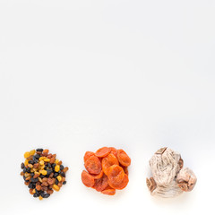 set of dried fruit on a white background. raisins, чернослив, dried apricots, persimmons. best candy in quarantine