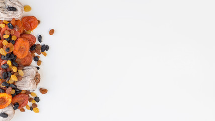 set of dried fruit on a white background. raisins, чернослив, dried apricots, persimmons. best candy in quarantine