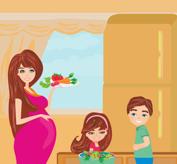 pregnant woman gives her children healthy food