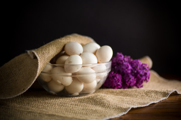organic homemade fresh eggs in a glass bowl under burlap