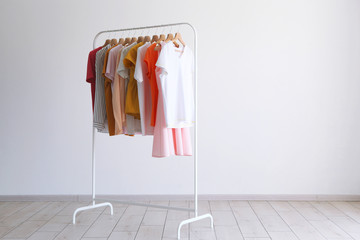 fashion clothes on a stand in a light background indoors. place for text
