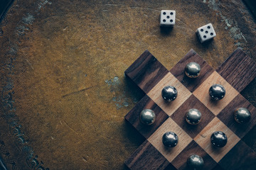 Tenet board game with dice on vintage leather background