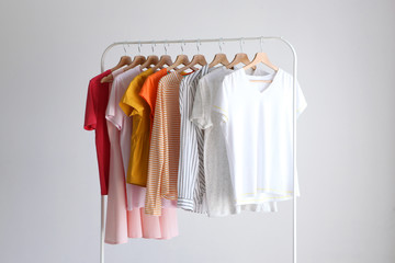 fashion clothes on a stand in a light background indoors. place for text
