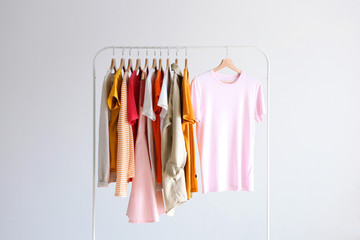 fashion clothes on a stand in a light background indoors. place for text
