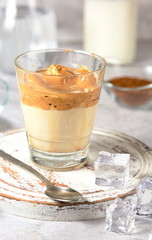 Dalgon coffee, a trendy fluffy creamy whipped coffee. Next to the ingredients for making a Korean refreshing coffee drink.