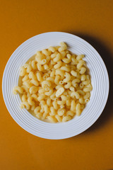 Macaroni on a white plate with butter