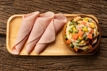 Top view, Pork ham and salad on wooden plate.