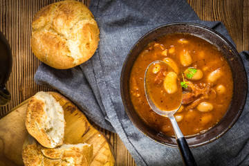 Beans with tomato sauce, bacon and sausage.