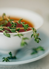 Herbal tea with fresh sprigs of blooming thyme