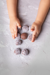 Super Fruit energy balls with coconut and truffles, vertical