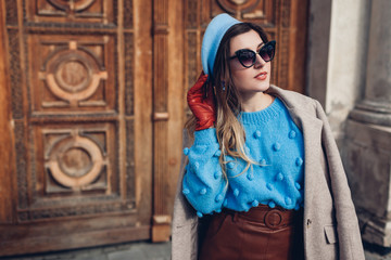 Spring vintage retro fashion female accessories and clothes. Woman wearing sweater beret leather skirt on street. - obrazy, fototapety, plakaty