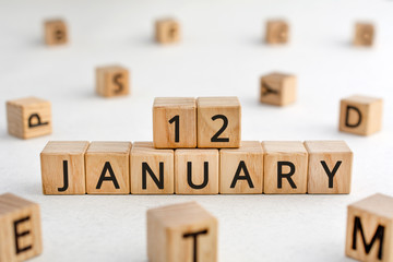 January 12 - from wooden blocks with letters, important date concept, white background random letters around