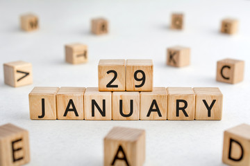 January 29 - from wooden blocks with letters, important date concept, white background random letters around