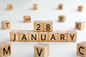 January 28 - from wooden blocks with letters, important date concept, white background random letters around