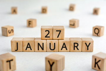 January 27 - from wooden blocks with letters, important date concept, white background random letters around