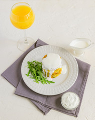 Healthy diet food concept. Tasty vegetable cutlet from carrot, zucchini, corn and pea with white sauce and glass of orange juice