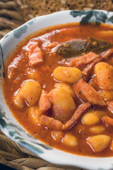 Beans with tomato sauce, bacon and sausage.