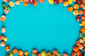 Frame of scattered corn kernels on a blue background.