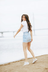 Young beautiful happy woman is relaxing on beach