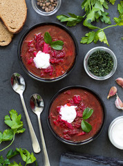 Vegetable beet soup in a bowl on a dark background top view