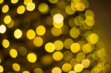 Lots of yellow garland lights with bokeh effect. New Year.