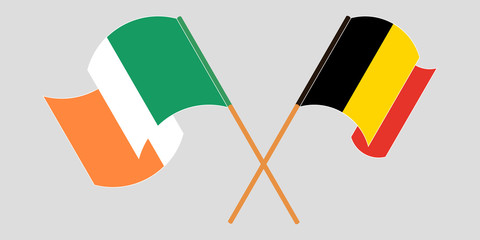 Crossed and waving flags of Ireland and Belgium