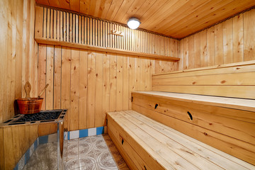 Traditional Finnish bath - sauna. Sauna wooden room with wooden benches and a stone stove