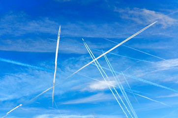 condensation trails on blue sky