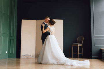 The bride and groom, European appearance. Rehearse the first wedding dance, or dance and whirl, holding hands. Wedding couple. Full-length photo.