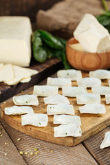 Russian national dish dumplings with cheese and spinach. On a blackboard with flour on a wooden dark table