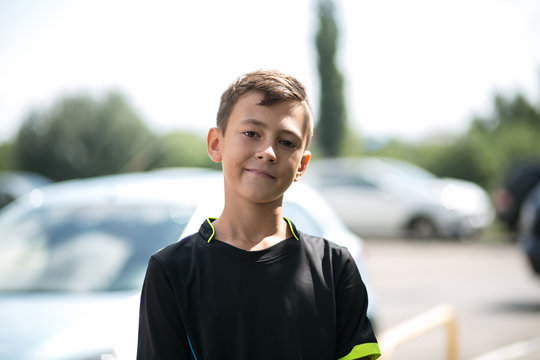 Teenage boy in street wear looking and smiling at the camera