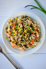 Asian steamed rice with sweet corn, green peas, red pepper and sesame seeds.