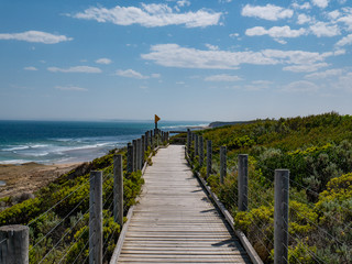 Fototapeta na wymiar boardwalk near beach on sunny summer day seaside