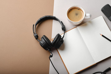 Flat lay composition with Microphone for podcasts  and black studio headphones on brown background with coffee and laptop, learning online education concept.