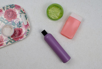 Flatlay cosmetic products on light background. Beauty set of coffee scrub, bank of gel aloe, cream, shampoo for face and body. Top view beauty flat lay.