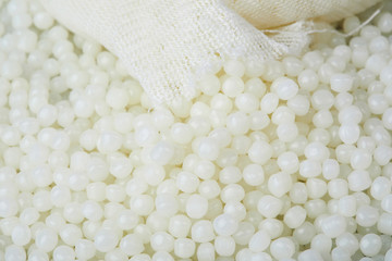 White PET granules, polymer resin, plastic granulate for injection molding process. Plastic pellets. Biodegradable plastic pellets.