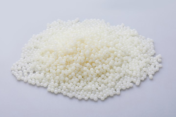 White PET granules, polymer resin, plastic granulate for injection molding process. Plastic pellets. Biodegradable plastic pellets.