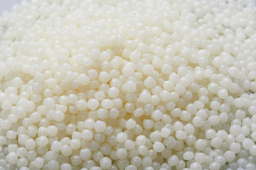 White PET granules, polymer resin, plastic granulate for injection molding process. Plastic pellets. Biodegradable plastic pellets.