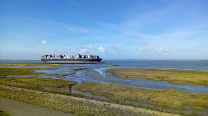 a beautiful coast landscape in zeeland of the westerschelde sea with a salt marsh in front and a...